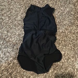 Black leotard with mesh panels, high neck and strappy back